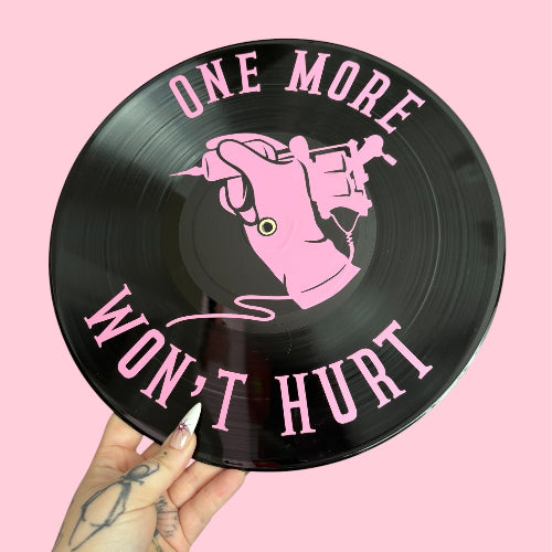 Vinyl record with pink text and graphic on a pink background