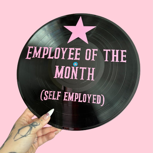 Vinyl record with 'Employee of the Month (Self Employed)' text and a pink star on a pink background.